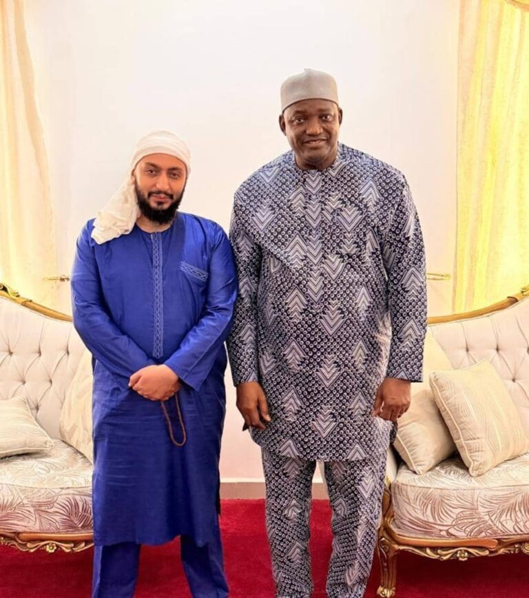 The President of The Gambia, His Excellency Adama Barrow, standing with a cofounder of Taibah Schools during an official meeting.